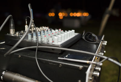 Close-up of sound mixers at night