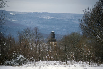 Scenic view of snow covered land and mountains against sky