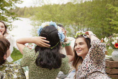 Women wearing flower wreaths at picnic