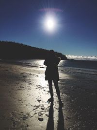 Silhouette of woman standing on beach