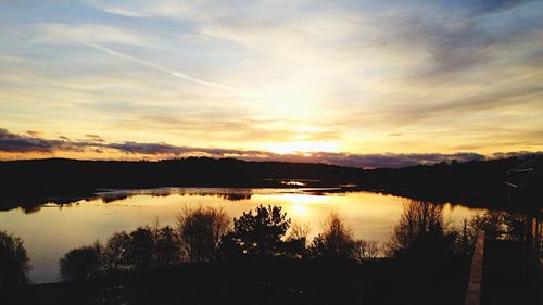 Scenic view of lake at sunset