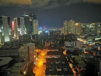 High angle view of illuminated buildings against sky at night