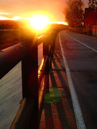 Close-up of railroad tracks against sunset