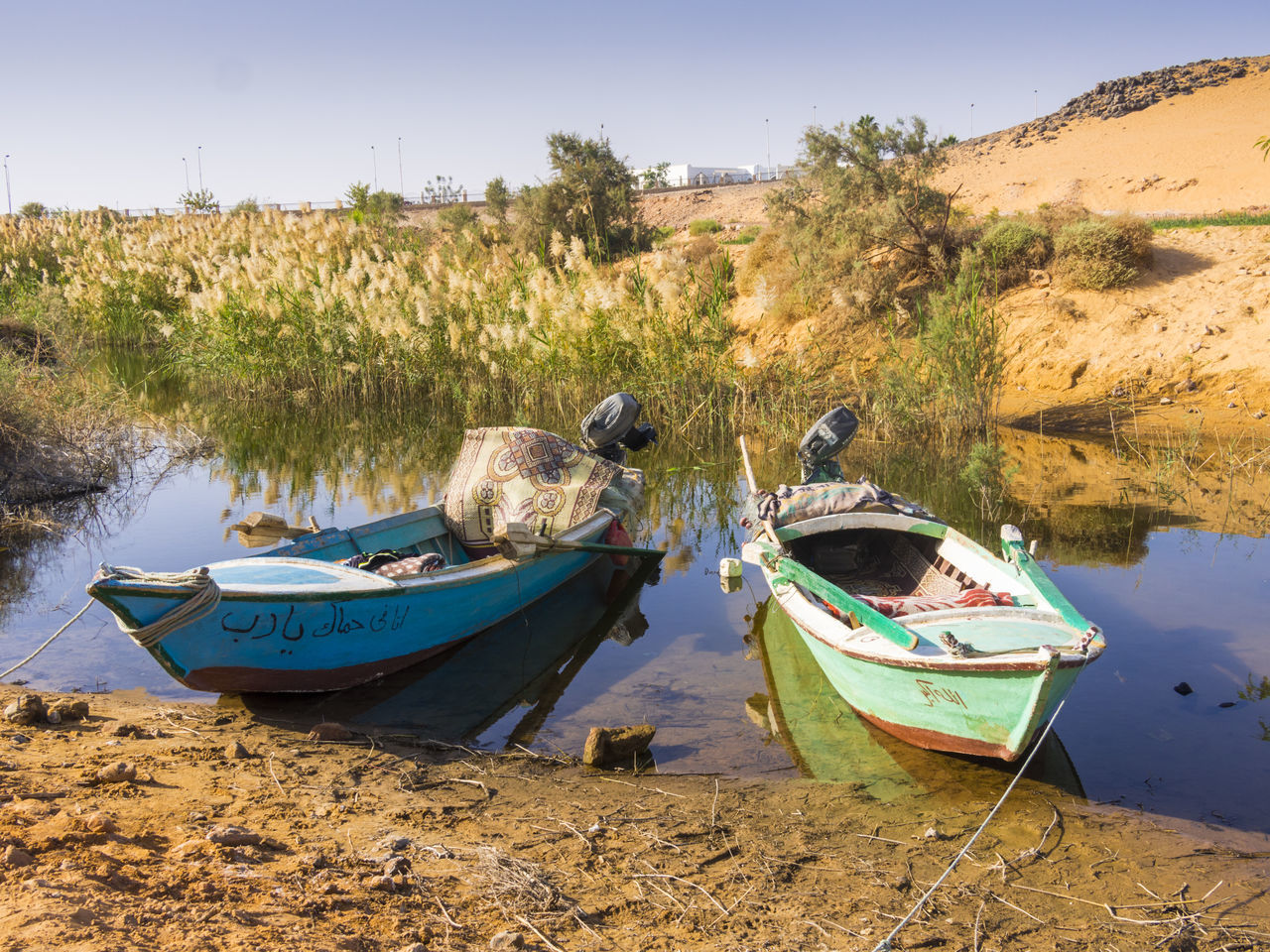 BOATS MOORED IN SEA