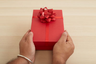 Close-up of hand holding red box