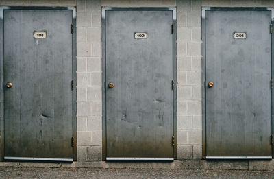 Three metal doors in a row.