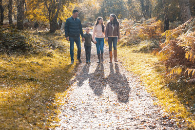 People standing by plants during autumn