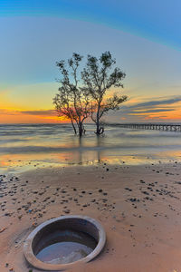 Scenic view of beach against sky during sunset