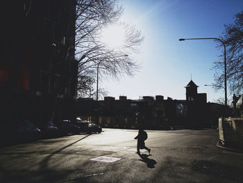 People walking on road along buildings