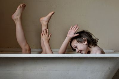 Playful brothers in bathtub at home