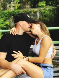 Couple embracing while sitting on bench