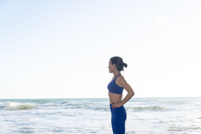 Sporty female looking out to sea before swimming in the ocean