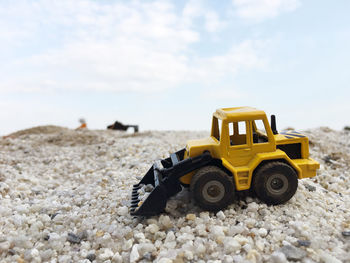 Toy earth mover on stones