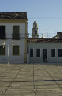 Houses by street in town against sky