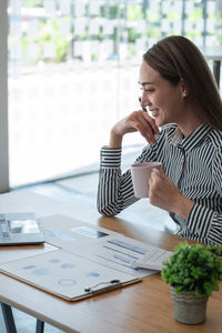 Businesswoman using laptop on table