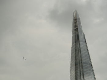 Low angle view of airplane flying against sky