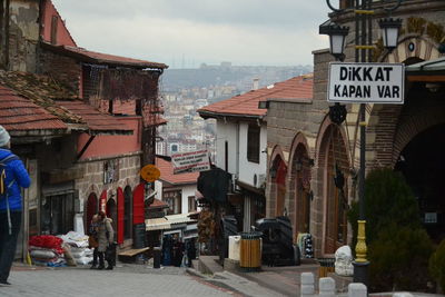 Street amidst buildings in city against sky