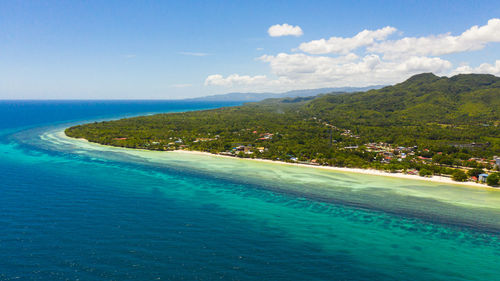 Coast with a beach and blue sea. anda bohol, philippines.