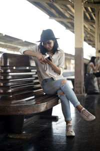 Portrait of young woman sitting on seat