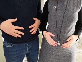 Midsection of couple holding hands