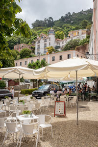 Group of people in restaurant against buildings in city