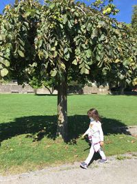 Side view of a girl looking at tree