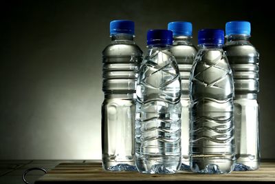 Close-up of water bottles against gray background