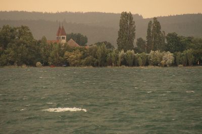 View of calm lake in front of church