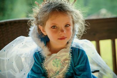 Portrait of cute girl wearing costume while sitting on bench