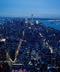 High angle view of city lit up at night