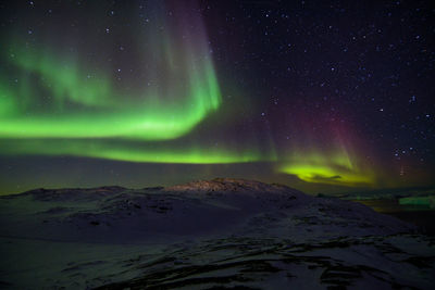 Scenic view of landscape against sky at night