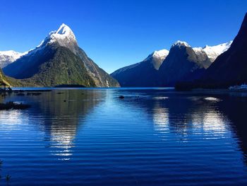 Scenic view of mountains against blue sky