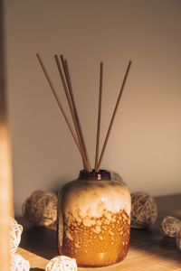 Cozy home decorations aroma reed diffuser in the living room. home comfort concept. bottle container