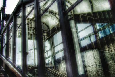 Low angle view of glass window in abandoned building
