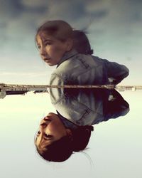 Portrait of young woman with reflection in lake