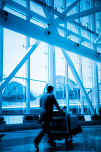 Rear view of man walking on airport