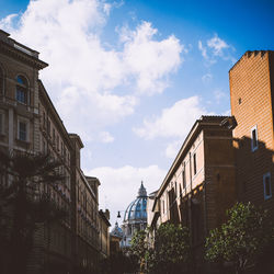 Low angle view of buildings against cloudy sky