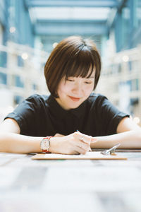 Portrait of woman sitting on table