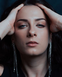 Close-up of young woman with hand in hair