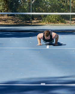 Full length of man exercising on court