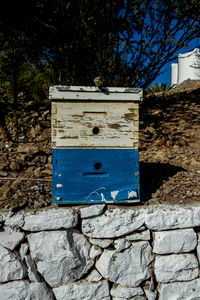Low angle view of mailbox on stone wall