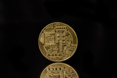 Close-up of coin against black background