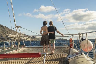 Couple hugging on a boat in the atlantic ocean by tenerife