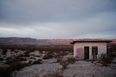 Abandoned building on field against sky