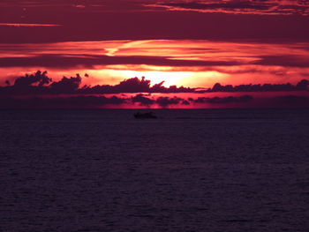 Scenic view of sea against romantic sky at sunset