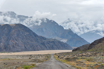 Road amidst mountains against sky