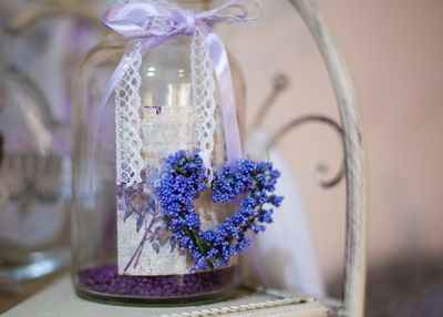 Close-up of purple flowers on glass table