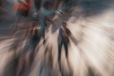 Blurred motion of people walking on street in city