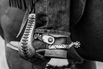 Low section of cowboy riding horse