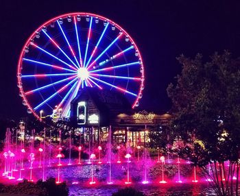 Low angle view of ferris wheel at night